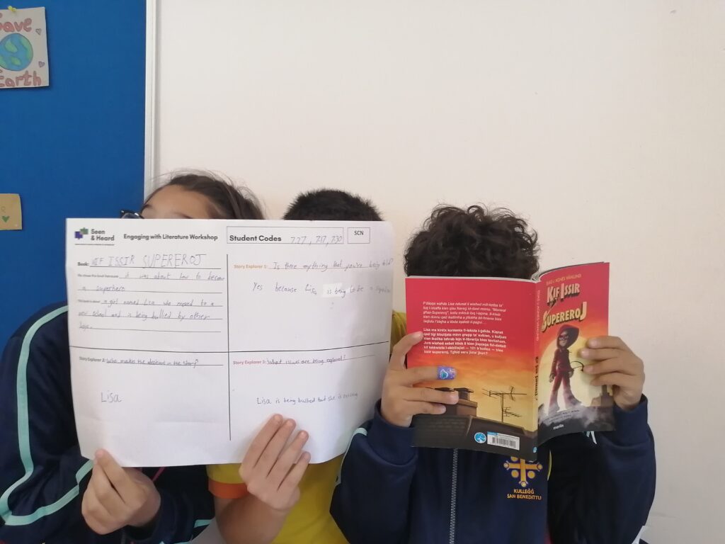 Children hiding behind books