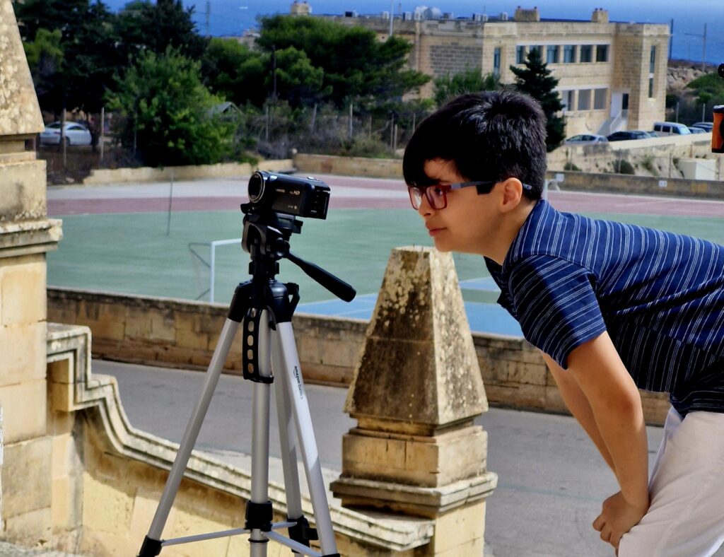 Boy making film with camera