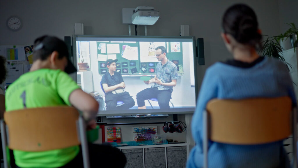 Children looking at a video presentation