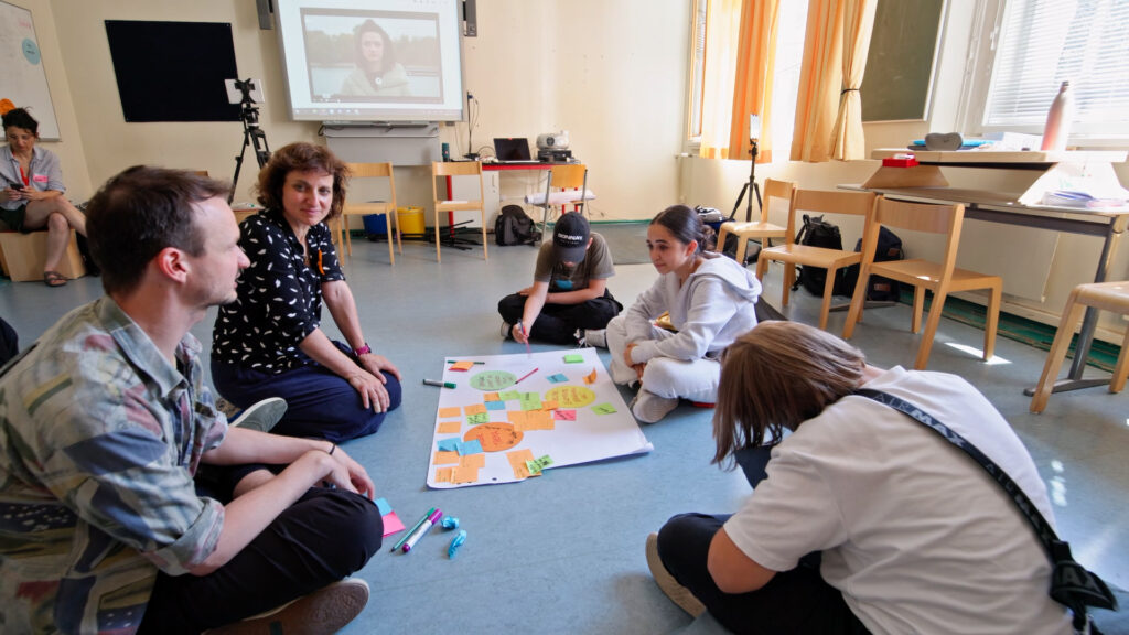 People of different generations discussing ideas in a classroom setting