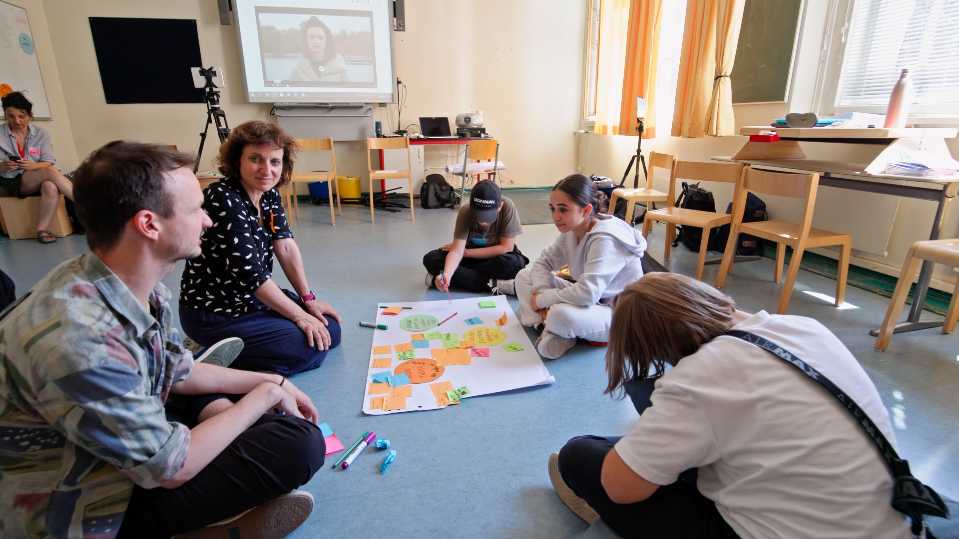 People of different generations discussing ideas in a classroom setting