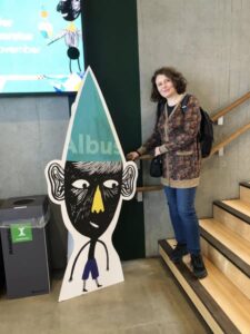 Person and cartoon figure at an event