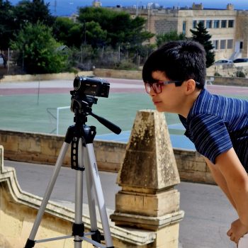 Boy making film with camera