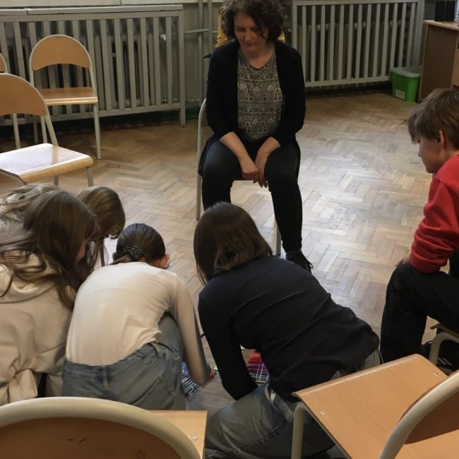 Children with tutor in classroom